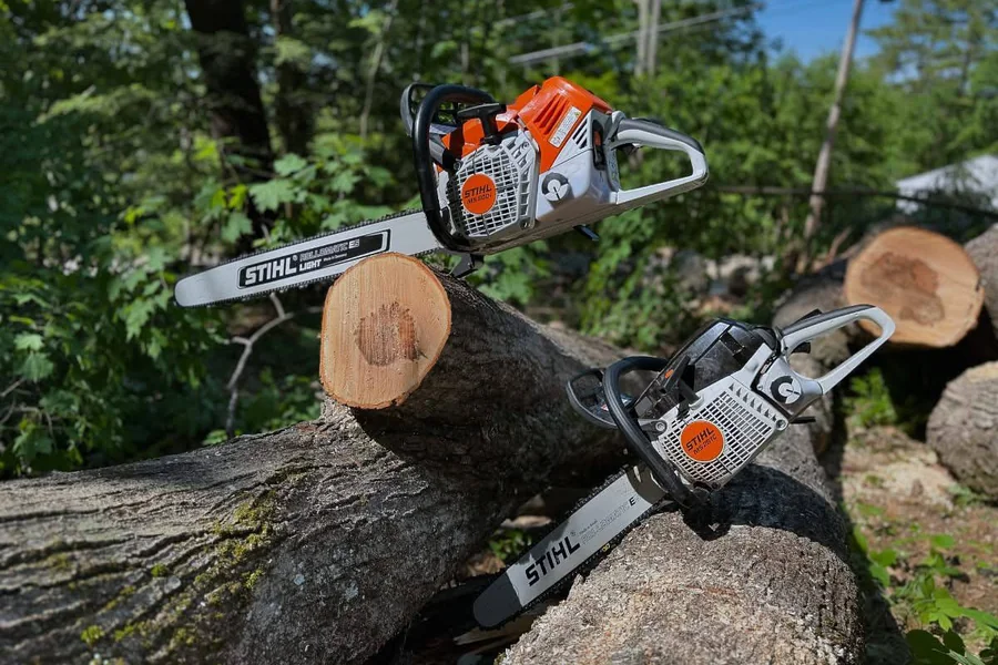 Two STIHL chainsaws on a fallen log