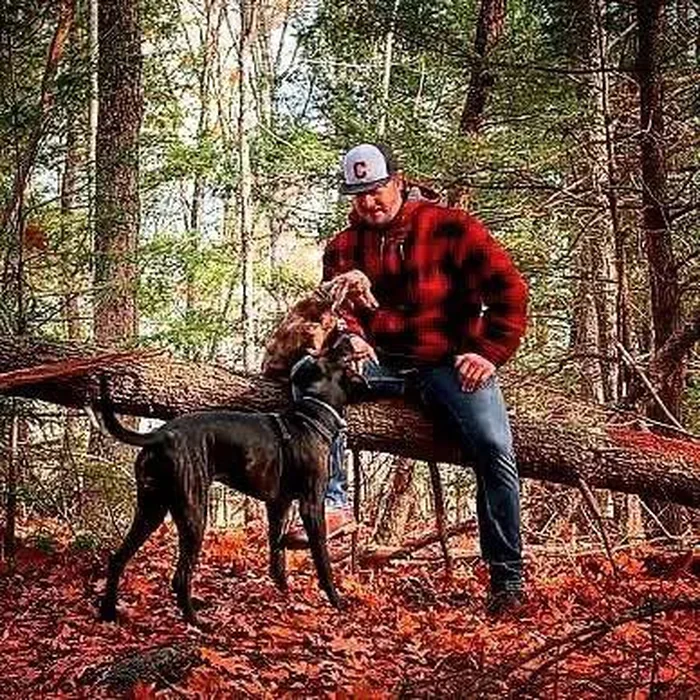 Torin with his dog in the woods